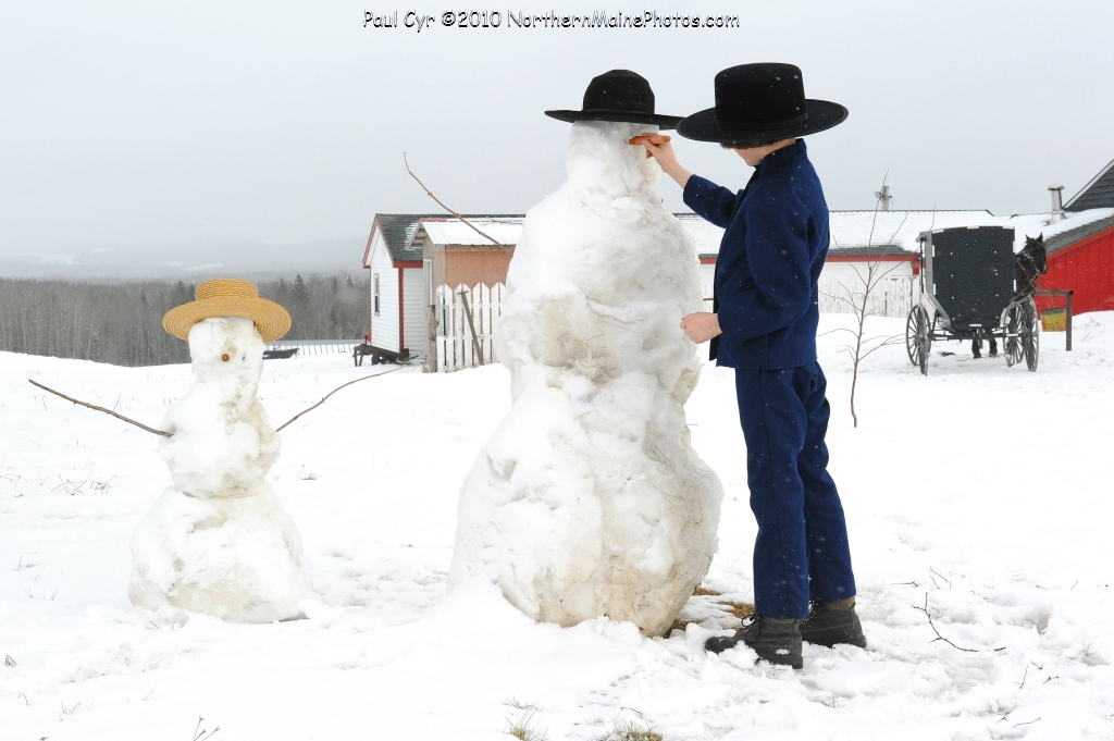 Amish Building a Snowman